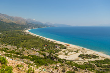 View on the Borsh Beach in Albania. Stony beach on the Adriatic Sea. Mountain in the background.
