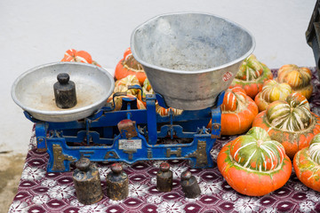 Old-fashioned balance scale with pumpkins