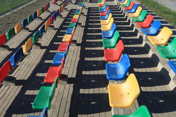  Colorful chairs on the stadium's platform