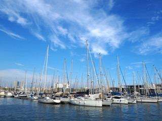 Fototapeta premium Port Vell in Barcelona, old harbor of Barcelona with an area of sports boats, yachts and a shopping area in Catalonia, Spain