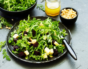 Fresh salad of arugula, beet and cheese.