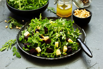 Fresh salad of arugula, beet and cheese.