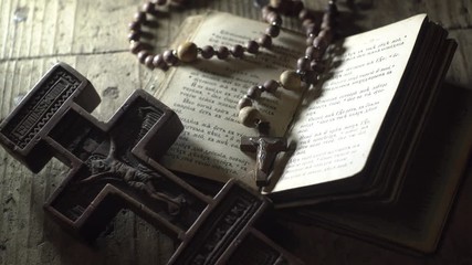 old prayer book rosary and old wooden cross in the dark - Powered by Adobe