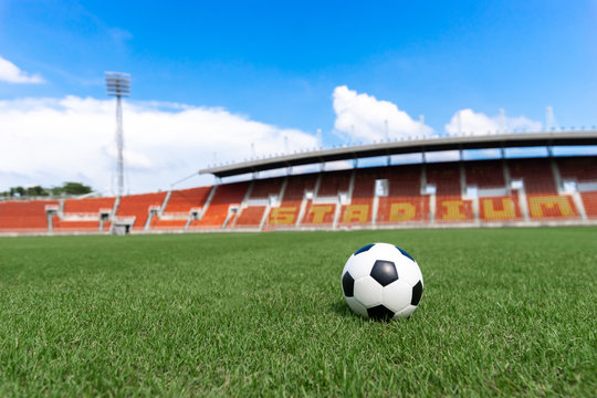 football field ball on green grass , soccer field athletics stadium and blue sky background