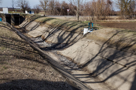  dry irrigation canal and water drainage system in zone of irrigated agriculture. Snow-white winter threatens a severe drought and crisis in agriculture. There is no harvest due to drought