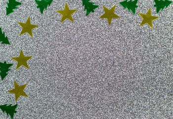 Christmas background concept-close-up of Christmas trees and stars on a glitter background.
