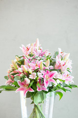 bouquet of lilies flowers on a gray background