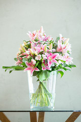 Fototapeta na wymiar bouquet of lilies flowers on a gray background