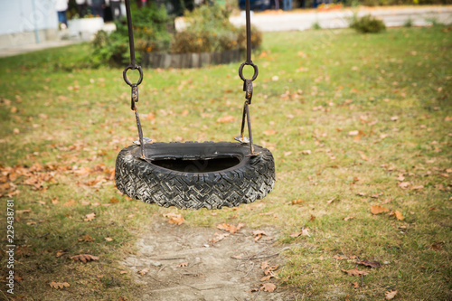 Tire Swing Hanging On A Tree In A Field Stock Photo And