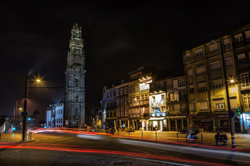 Fototapeta na wymiar Traditional streets of Porto with lights of cars near the Torre dos Clerigos.