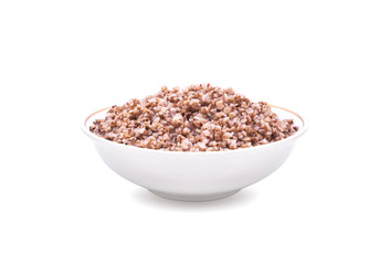 Buckwheat boiled in white deep plate. Isolated on white