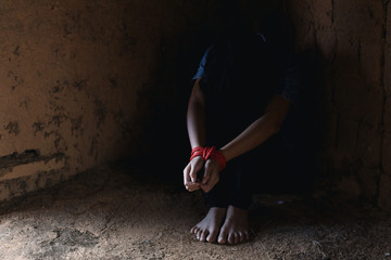 Kidnapped little girl tied with rope.Abused and tortured concept. Human trafficking concept. Stop...