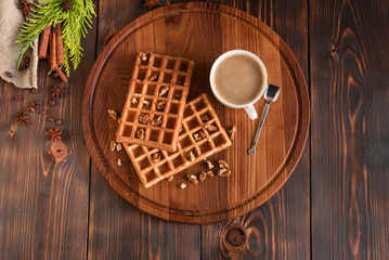 Tasty fresh Vienna wafers, jam and cup of coffee on a dark wooden background