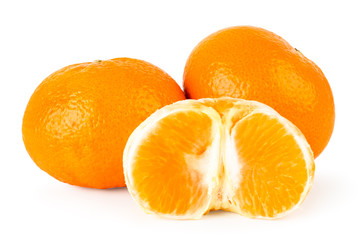 Ripe tangerines and peeled half close - up on a white. Isolated