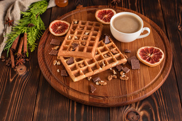Fototapeta na wymiar Tasty fresh Vienna wafers, jam and cup of coffee on a dark wooden background