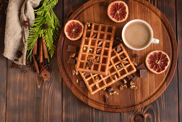 Tasty fresh Vienna wafers, jam and cup of coffee on a dark wooden background