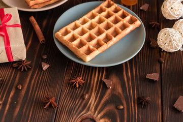Tasty fresh Vienna wafers, jam and cup of coffee on a dark wooden background