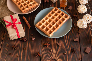 Tasty fresh Vienna wafers, jam and cup of coffee on a dark wooden background