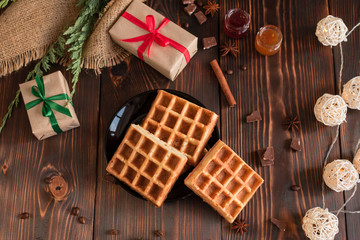 Tasty fresh Vienna wafers, jam and cup of coffee on a dark wooden background