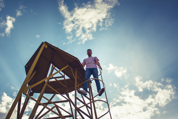 Man standing calmly on round metal construction