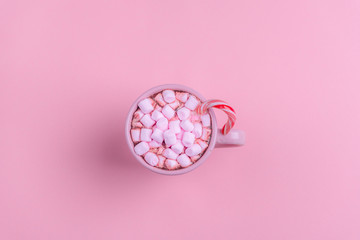 Hot drink with marshmallows and candy cane
