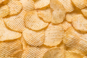 Close up Crispy potatoes chips isolated on white background top view. Food background. 