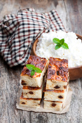 Homemade cottage cheese casserole slices on wooden table