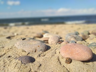 Fototapeta na wymiar Stones buried in the sand