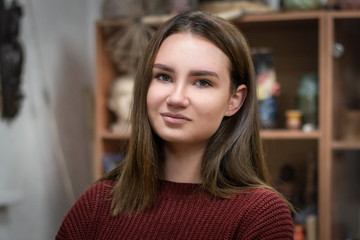 Portrait of a girl on the background of the workshop