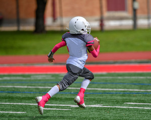 Little boys and girls playing youth tackle football