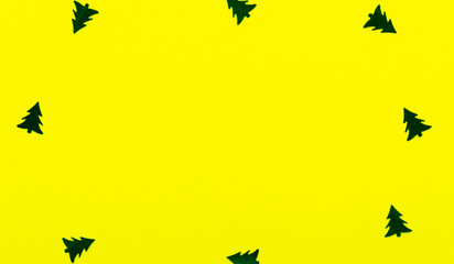 Background Christmas decoration-christmas trees,stars on a yellow background and copy space.