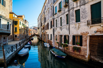 Obraz na płótnie Canvas A venetian canal with medieval buildings and gondolas