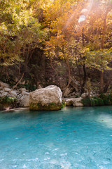 A turquoise river through the forest in Greece
