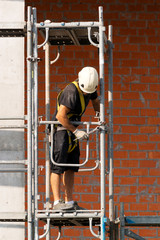 worker in construction site of new building in city