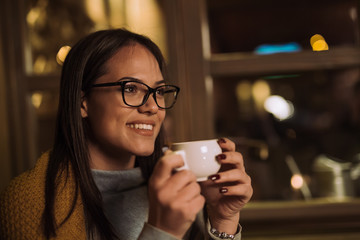 Smiling woman holding coffee
