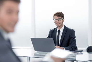 Fototapeta premium businessman in suit in office using tablet