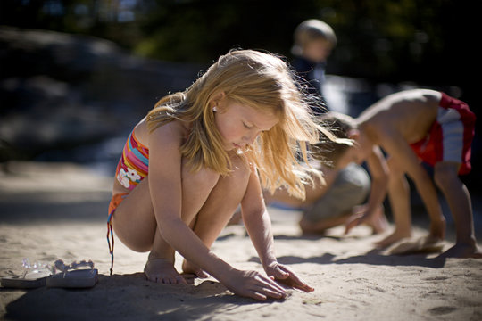 Girl building sand castle on the beach