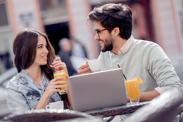 Happy couple spending time at coffee shop