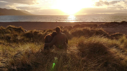Young couple in love on the beach at sunset