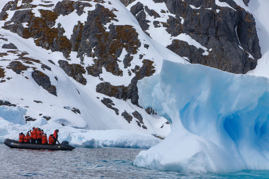 People on boat looking at polar landscape, Antarctica
