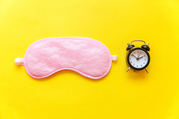 Sleeping eye mask, alarm clock isolated on yellow colourful trendy background. Do not disturb me,...
