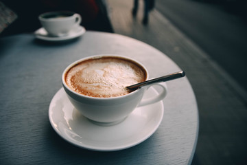  fresh cappuccino coffee with a pattern. veranda cafe in the city.