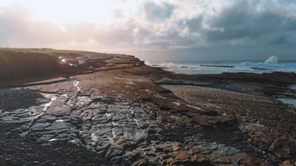 Low Aerial view over the rocky bay of Kilkee at the Irish west coast