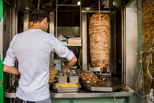 Person cooking a gyro