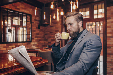 Young handsome businessman reading a newspaper