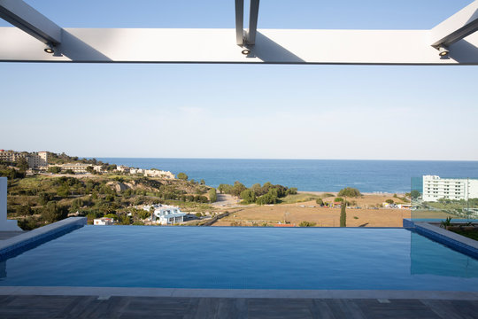 Swimming pool overlooking town, Greece