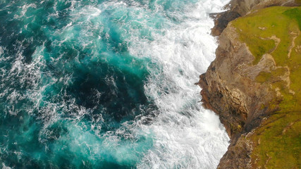 Aerial view over the wild Atlantic Ocean Water at the steep cliffs of Ireland