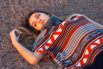 Autumn portrait of a girl in ethnic sweater