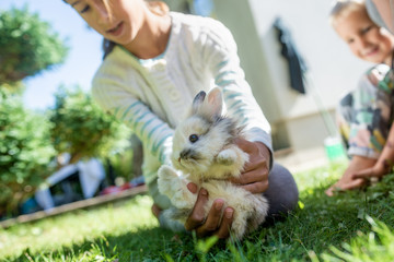 Girl holding her furry little pet rabbit