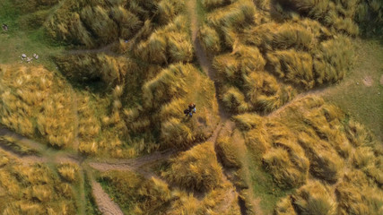 Flight above a couple that stands on a hill